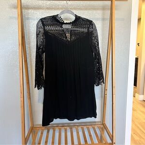 En Creme black, lace long sleeve dress. Size small.